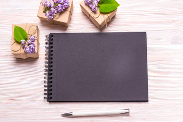 Black notebook and Hyacinth flowers on wood background