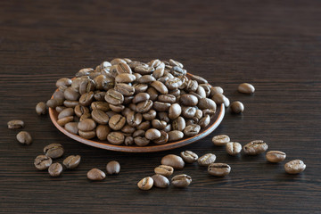 Coffee beans on a wooden background. Close up