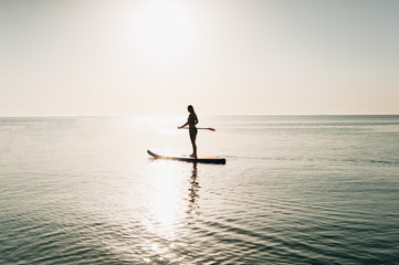 silhouette of a sexy athletic girl who sails on kayaks