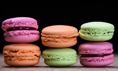 Fototapeta na wymiar Colourful and sweet french macaroons on wooden background