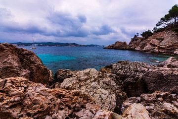 Fototapeta na wymiar Mediterranean seascape with dramatic sky rocks and stones. In Spain