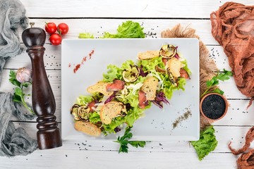 Caesar salad with salmon. Top view. On a wooden background. Copy space.