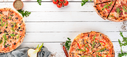 Set pizza. Italian cuisine. Top view. On a wooden background. Copy space.