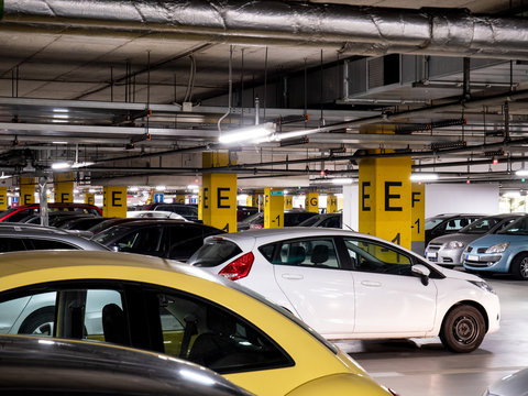 Underground garage in a shopping mall with a lot of cars
