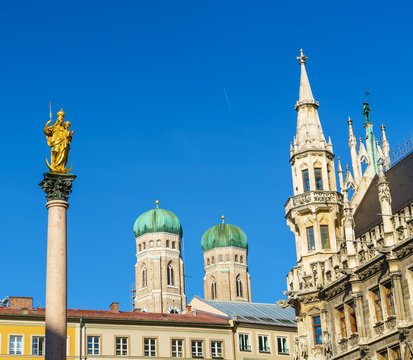Marian column (1639) or Mariensaule with statue of Virgin Mary on the top and Neues Rathaus, Munich, Germany