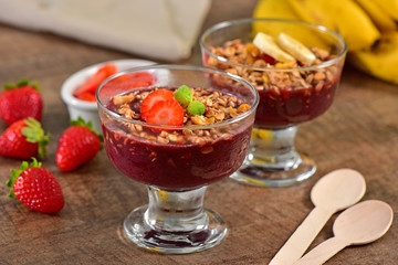 Acai berry cups on wooden background