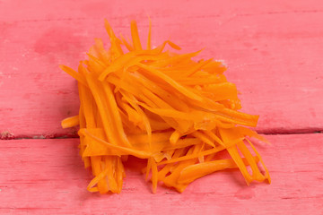 carrot sliced on pink wood
