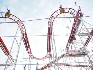Red roller coaster against the sky in Cologne