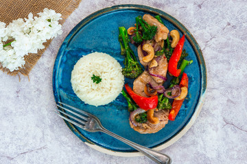 Sichuan pork, broccoli, red pepper and cashew stir-fry with rice - top view