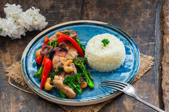 Sichuan pork, broccoli, red pepper and cashew stir-fry with rice