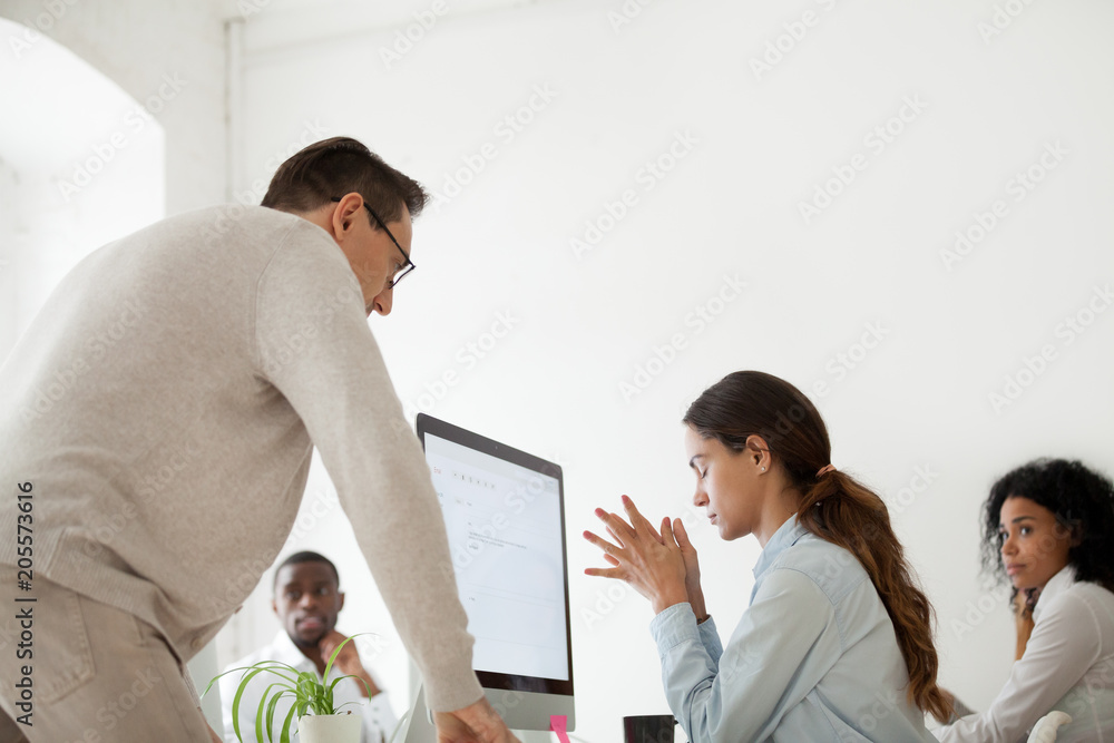 Wall mural angry boss scolding criticizing firing stressed intern for incompetence in multiracial office, sad f