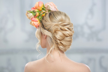 Obraz na płótnie Canvas Blonde girl with elegant wedding hairstyle view from behind.