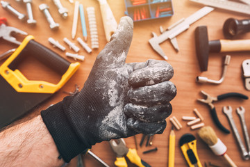 Repairman showing OK thumb up approval hand sign, top view