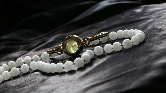 Pearl Necklace and gold watch 
