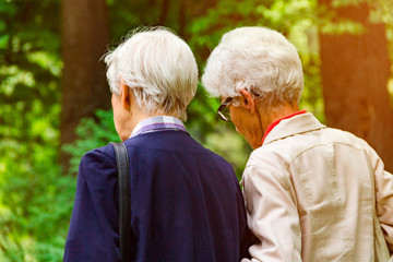 Older women laugh. Happy ladies are fooling around the park. Friendship has been tested for years.