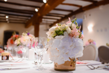 Dining table setting at Provence style, with candles, lavender, vintage crockery and cutlery, closeup. Beautiful wedding decoration with flowers pink violet purple white colors