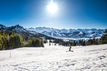 Fototapeta na wymiar Beautiful winter landscape picture. Skier skiing in Swiss Alps, Ibergeregg, Switzerland
