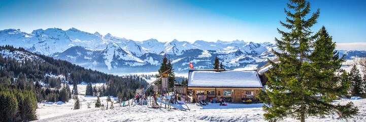 Beautiful winter landscape. Chalet covered by fresh snow in Ibergeregg, Switzerland, Europe.