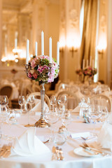 Luxurious luxury restaurant hall prepared for wedding dinner. Serving. Table appointment catering. Summer party. Preparing for reception or dance