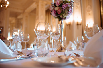 Luxurious luxury restaurant hall prepared for wedding dinner. Serving. Table appointment catering. Summer party. Preparing for reception or dance