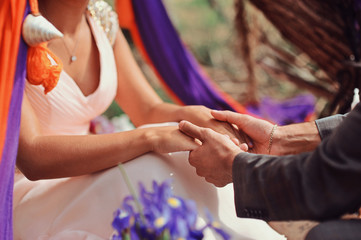 Hands of newlyweds or young lovely couple. Pair of lovers hands close up. East Love together concept