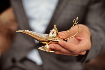 Magic lamp in the desert from the story of Aladdin with Genie concept for wishing, luck and magic. Fairy tale magic about love and together dreaming
