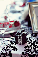 Wedding table decoration with flowers and art elements. Wedding decor. Close up of table appointments. Luxury catering at event