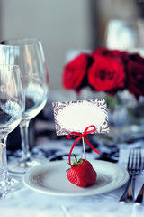 Wedding table decoration with flowers and art elements. Wedding decor. Close up of table appointments. Luxury catering at event