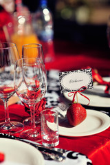 Wedding table decoration with flowers and art elements. Wedding decor. Close up of table appointments. Luxury catering at event