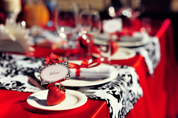 Wedding table decoration with flowers and art elements. Wedding decor. Close up of table appointments. Luxury catering at event