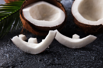 Ripe half cut coconut on a wooden background