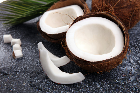Ripe half cut coconut on a wooden background