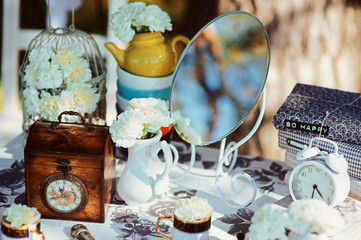 Holiday themed table for the tea ceremony. Table with sweets. Tea with sweets. Table of Alice in...