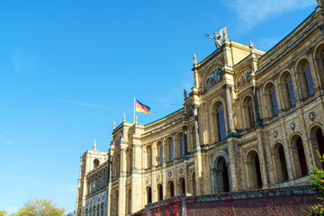 Waving German flag above The Maximilianeum (1874), seat of Bavarian Landtag, Munich, Germany
