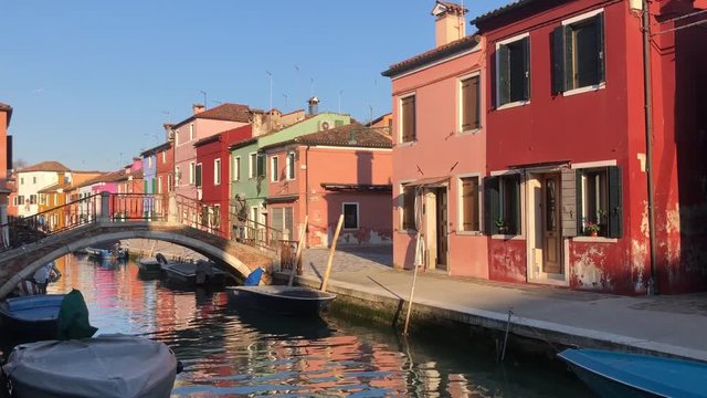 bridge over canal with multicolored houses of Burano island, Venice, Italy