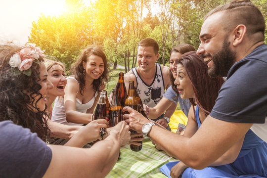 freunde stoßen auf ihre freundschaft an. anstoßen mit bier in flaschen. fokus auf mann in der mitte