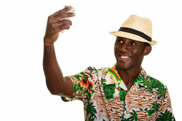 Young happy black African man smiling and taking selfie with mob