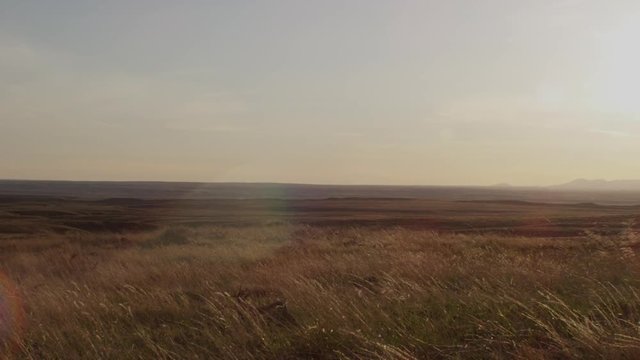 Dolly left high prairie at sunset golden light