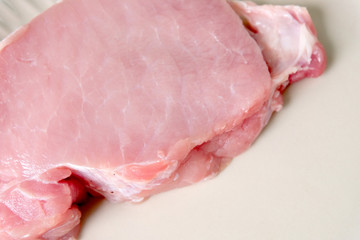 close up slice of raw pork ,soft focus