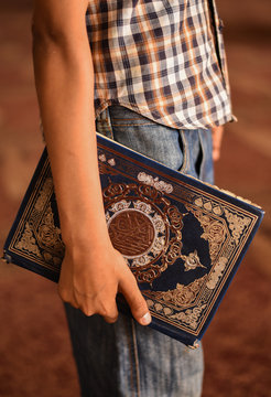 Man holding the Quran