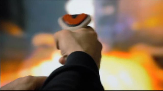 Analog capture (intentional heavy distortion fx): playing with a retro vintage joystick (input device for computer games) with a shooting videogame. Colorful explosions, game over screen.