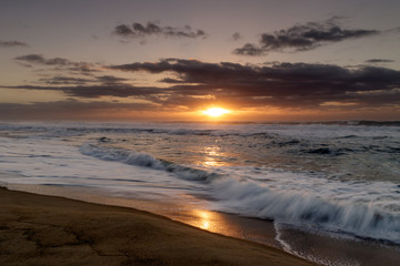 Sunrise on Diamond Beach, long sandy beach with waves