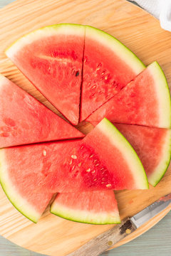 Slices of watermelon on a wood cutting board