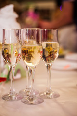 Glasses with white wine on blurred background