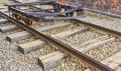 Fototapeta premium Old rusty delapidated railroad cart on a track