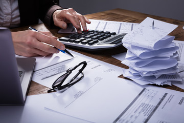 Businessperson Calculating Invoice