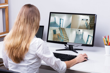 Businesswoman Looking At CCTV Footage On Computer