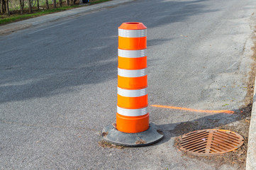The orange traffic cone on the sidewalk in Montreal downtown, Canada