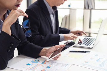 Business team two colleagues discussing working with many document graph in team Meeting Talking Brainstorming Communication Concept