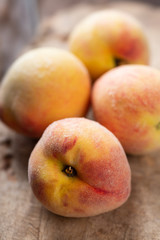 Fototapeta na wymiar Ripe peaches on wooden, tropical fruit